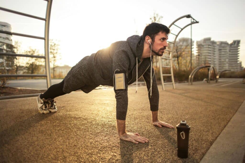 man exercising with earphones and wearable