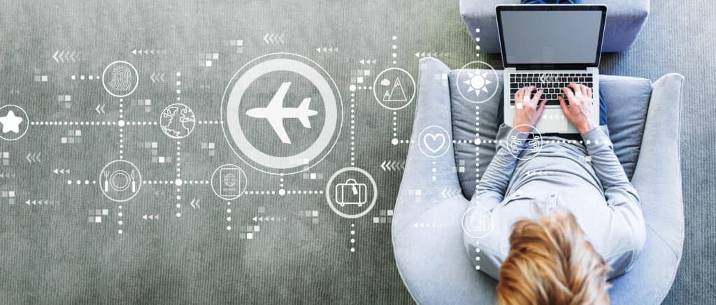 Airplane travel media theme with man using a laptop in a modern gray chair